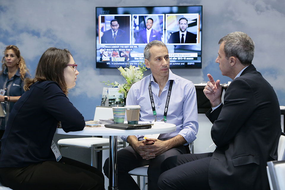 Three people having a conversation in NPE's National Business Lounge